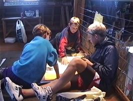 Tristan, Daniel and Peter T play one of the games at the visitor centre